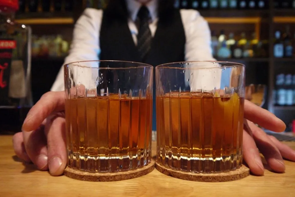 Two cocktails served at a bar