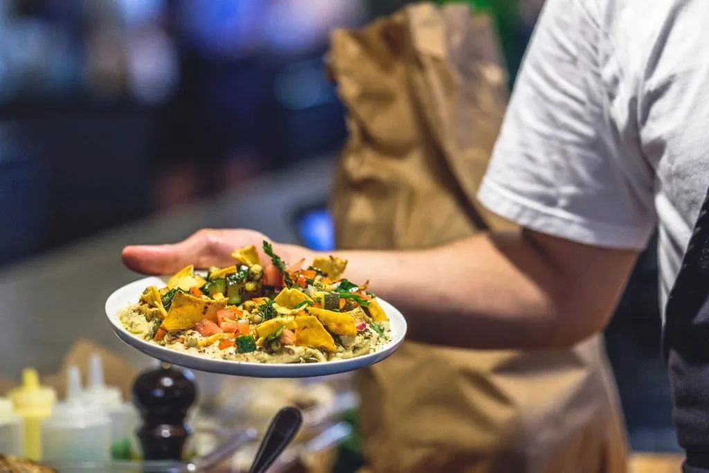 Server carrying a plated dish